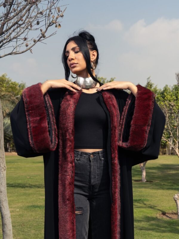 Black crepe kaftan with burgundy fur details on the sleeves and front for a bold and luxurious touch. - Image 2