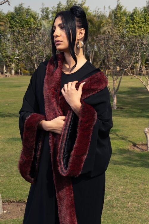 Black crepe kaftan with burgundy fur details on the sleeves and front for a bold and luxurious touch.
