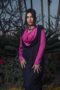Draped collar dress paired with a long vest for a chic and modern style