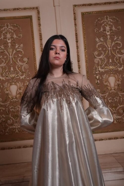 This stunning couture gown, crafted from luxurious Gold Sirma , features delicate tulle embroidery that adds a touch of magic. A truly special piece for your most memorable occasions.  Couture Collection